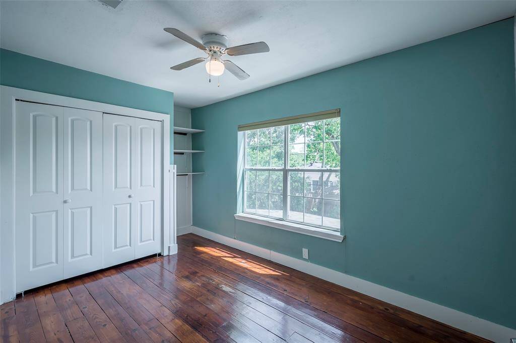 This secondary bedroom measures 12x9 with good closet space, ceiling fan and shelving for additional storage.