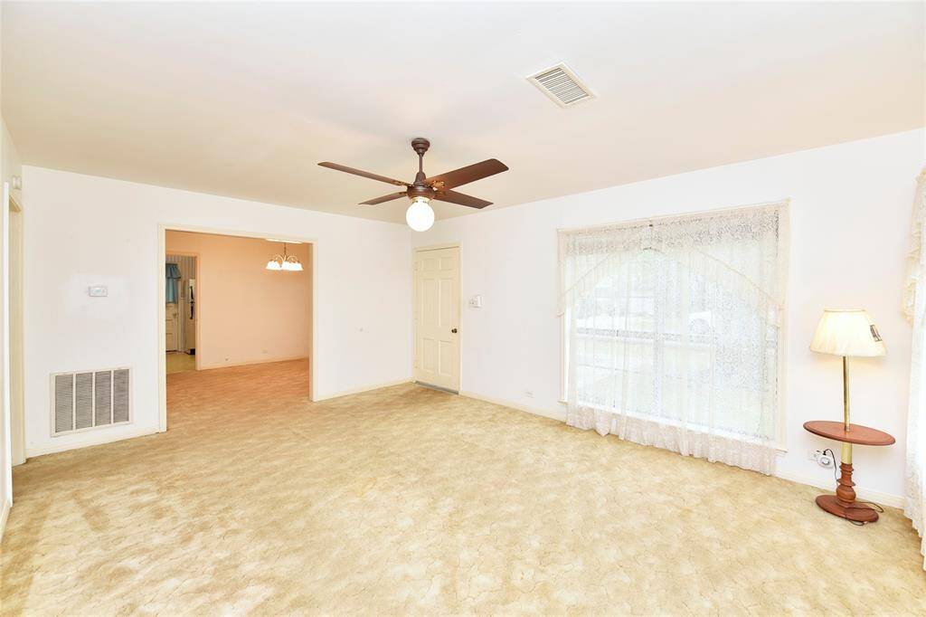 This view of the living room is looking into the formal dining that also has OAK Floors under the carpet.