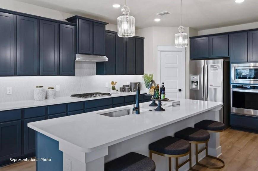 The sleek countertops, with their soft veining, invite you to gather around, whether for a quick breakfast or a weekend feast with friends.