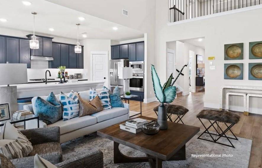 Imagine walking into a home that feels as expansive as it is inviting, bathed in natural light and framed by soaring ceilings that make every moment feel grand.