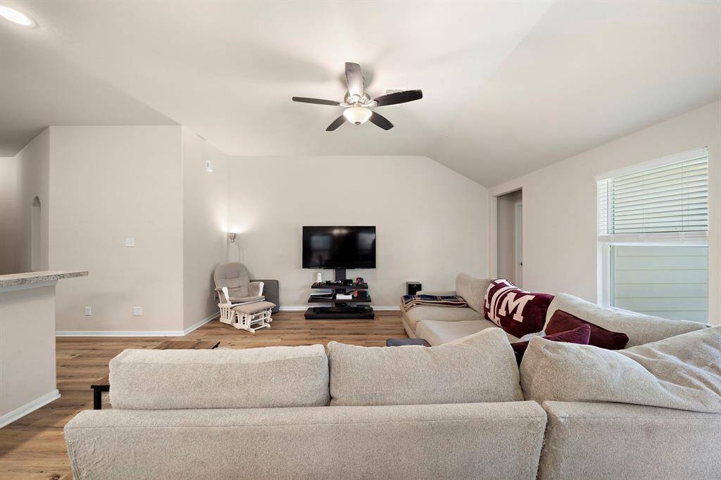 The living room open layout and neutral tones create a spacious and welcoming atmosphere.