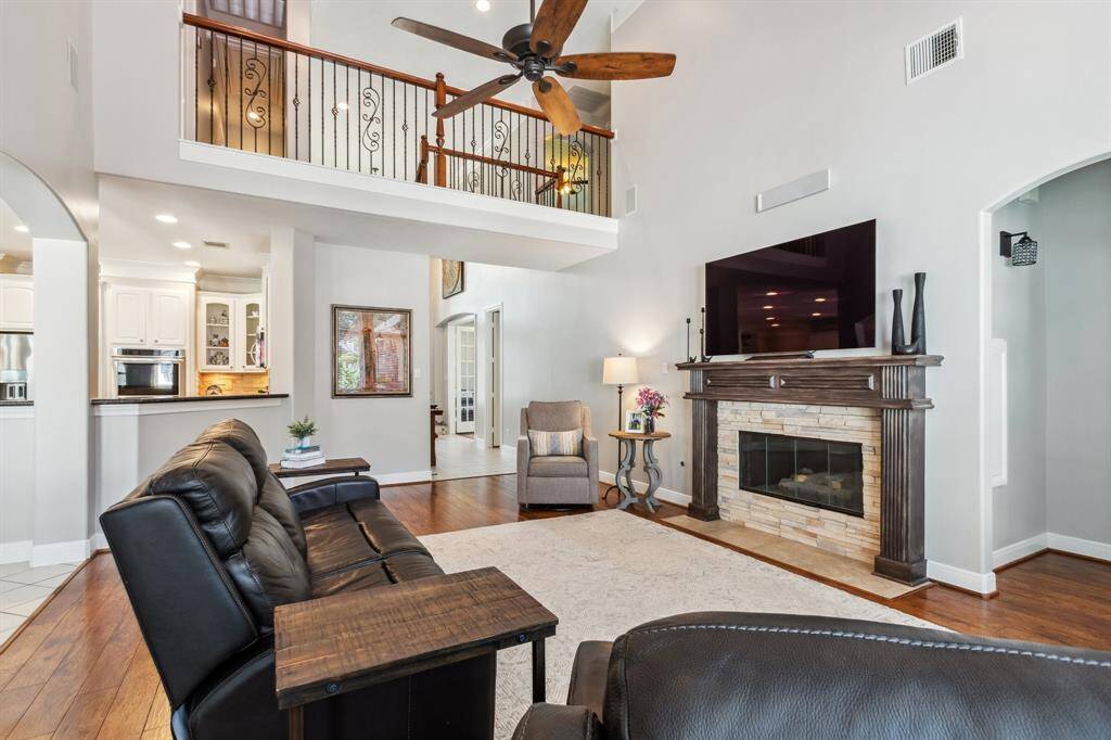 Family room features stone front fireplace with custom built mantle. Tall ceilings for an open and airy feel.