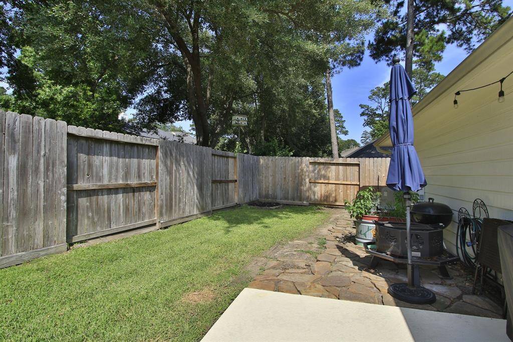 Backyard behind garage with patio for grilling and it's plumbed for natural gas for your grill.