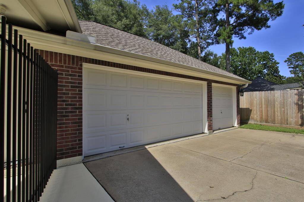 Oversized 3 car garage with storage space on the side and in front of where you park your car.