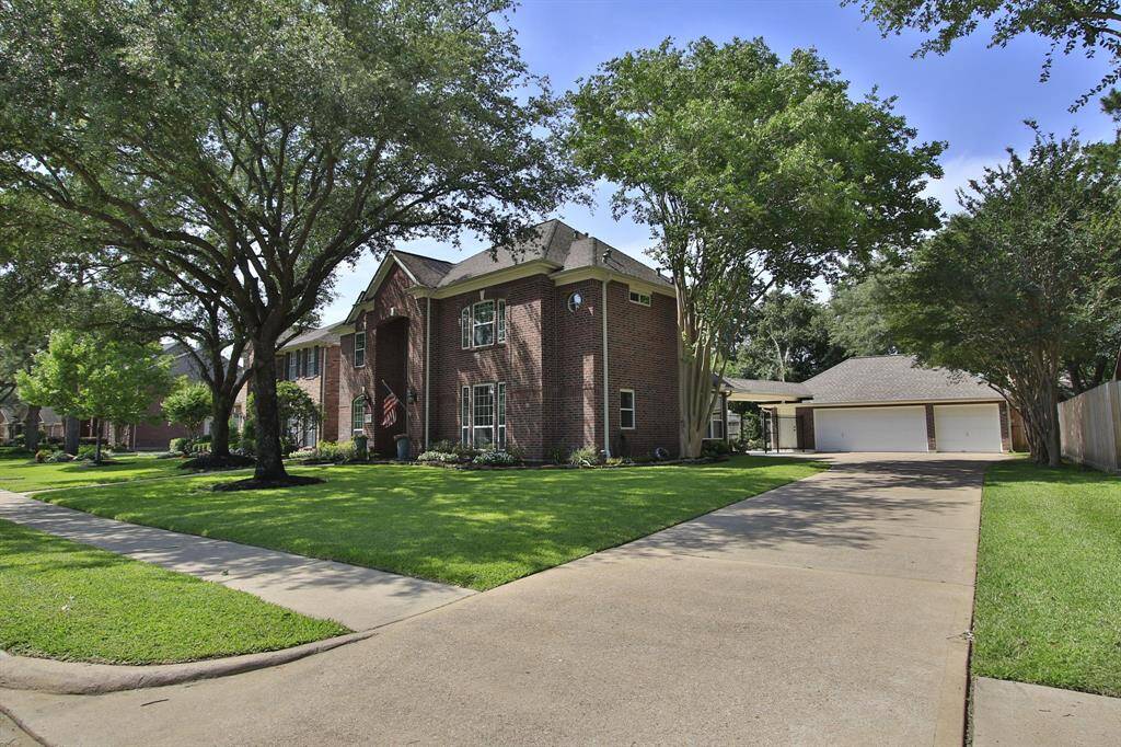 Long driveway leading to 3 car garage.