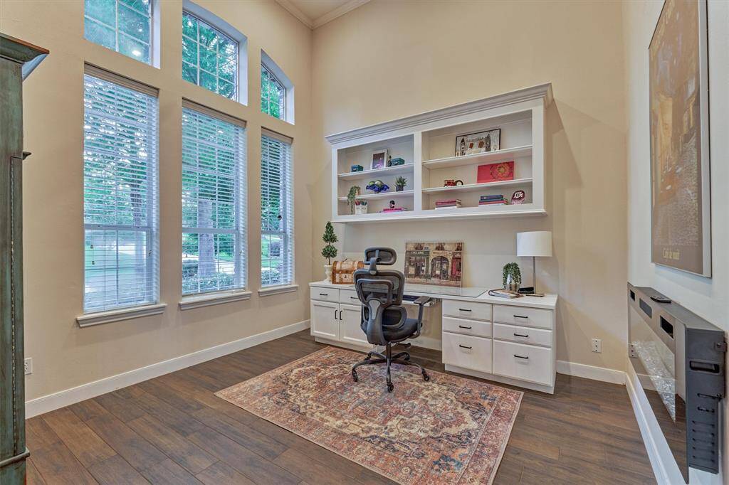 Located just off the entry, the home office offers a quiet and functional workspace with a large window overlooking the front yard. Built-in shelving and cabinetry provide ample storage for files, books, and office essentials.