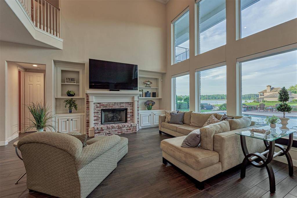 Another view of the living room shows custom built-ins and that beautiful lake view.