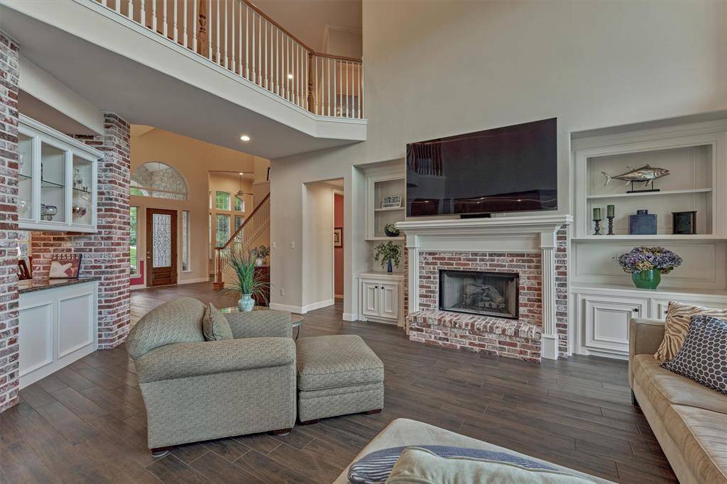 A gas log fireplace serves as a stunning focal point, finished in matching brick that complements the nearby bar and buffet.