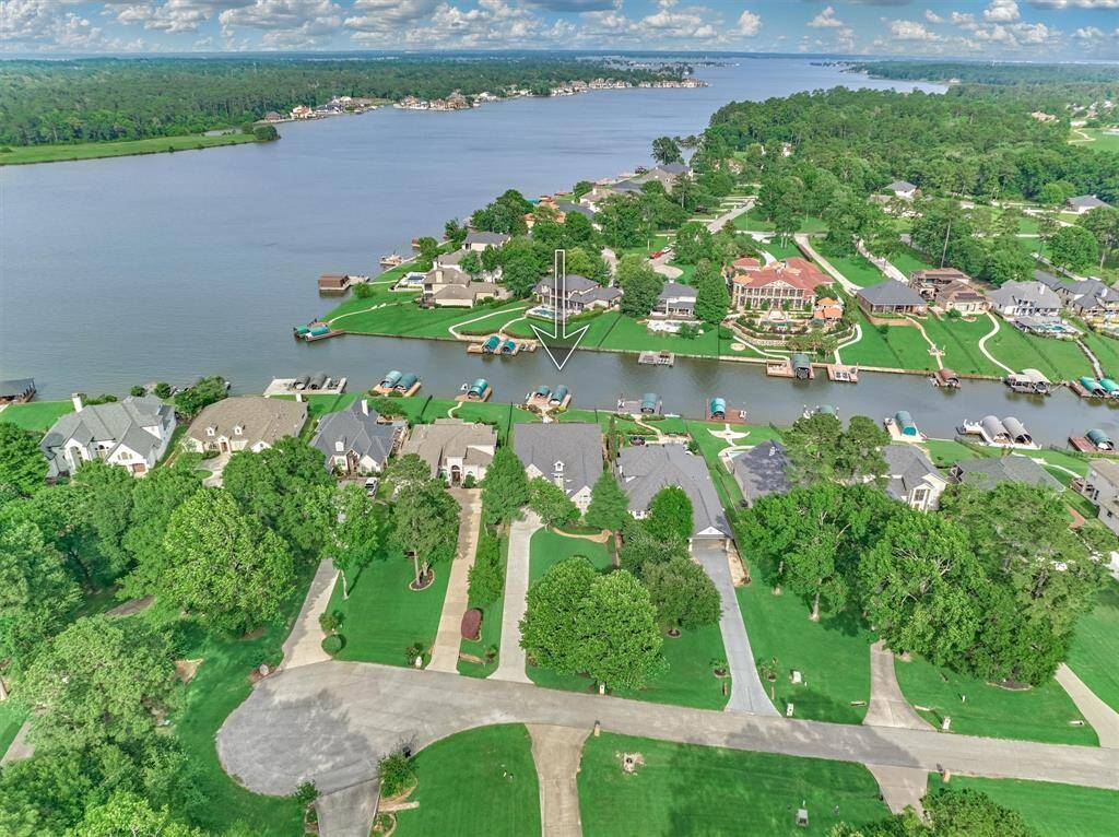 Situated on a gated cul-de-sac in the highly sought-after Grand Harbor community, this home offers direct lake access and is just seconds from open water on Lake Conroe.
