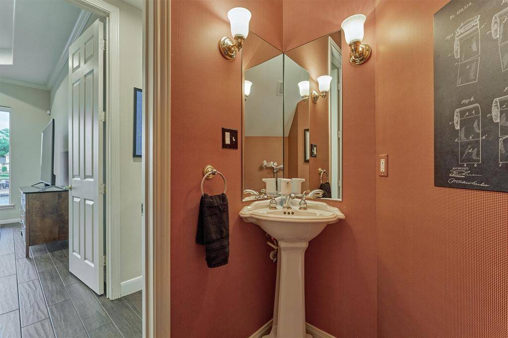 The half bath is conveniently situated just off the living room, offering easy access for guests.
