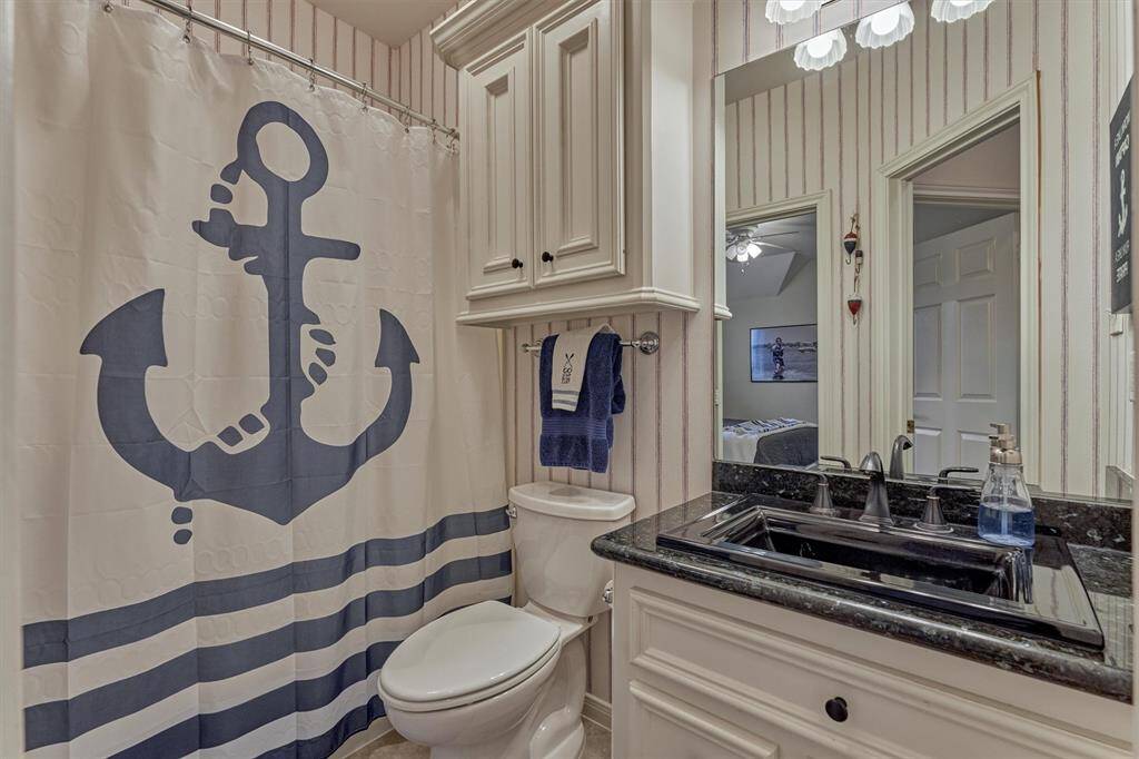 The first of two full baths upstairs is located between the game room and first guest bedroom.