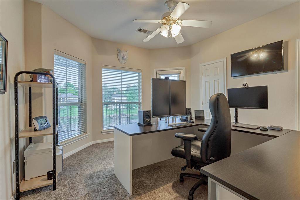 A second guest bedroom is currently being used as a second office. A bay window overlooks the pool and lake and a glass door leads to a private second floor balcony. This room has a private sink area and shares a Hollywood bath with another bedroom.