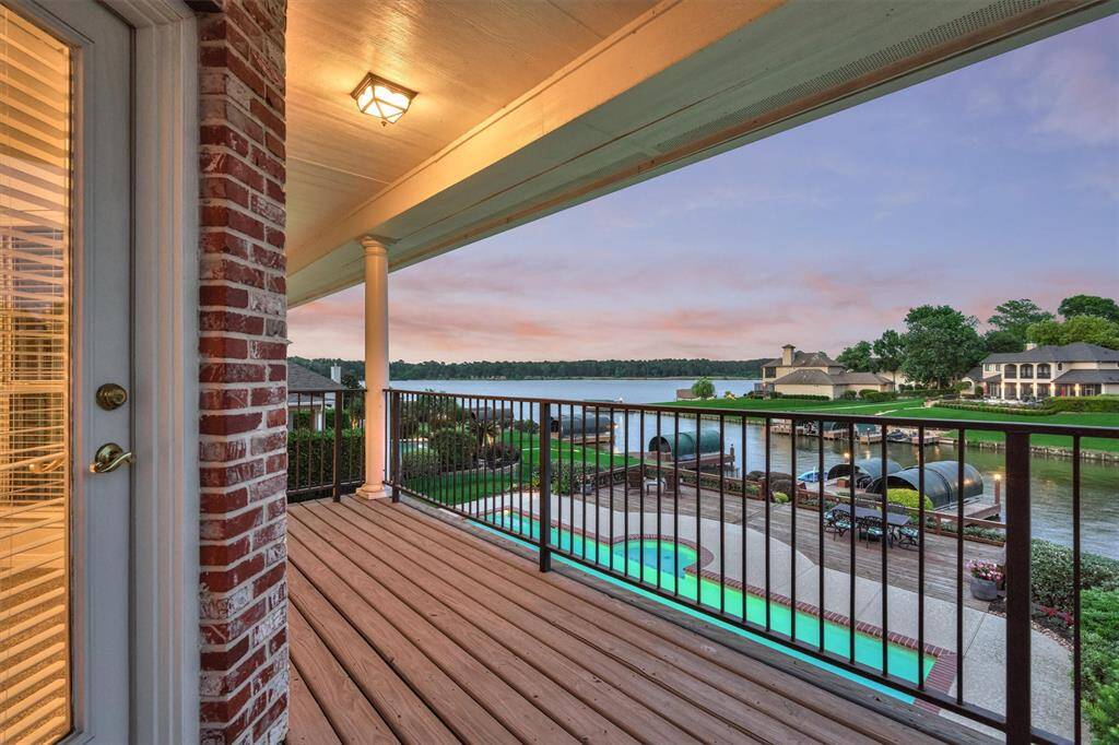The private second floor balcony off of this bedroom has beautiful views of the pool, back yard and lake.
