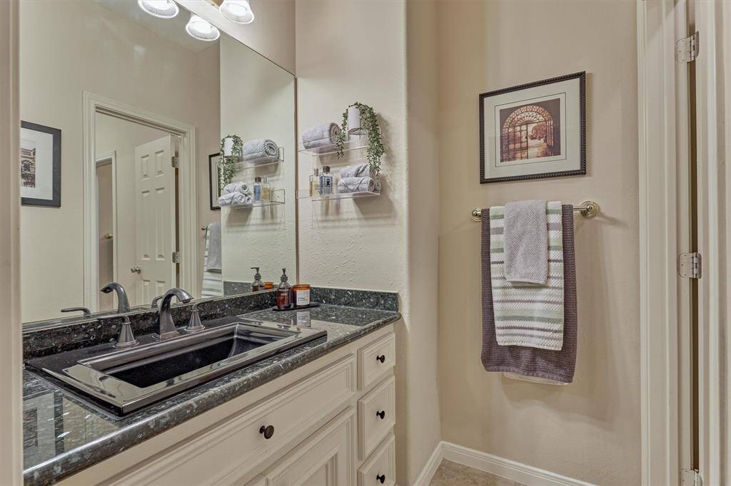 This private sink area is part of the Hollywood bath leading to a shared tub and toilet area between two guest bedrooms.