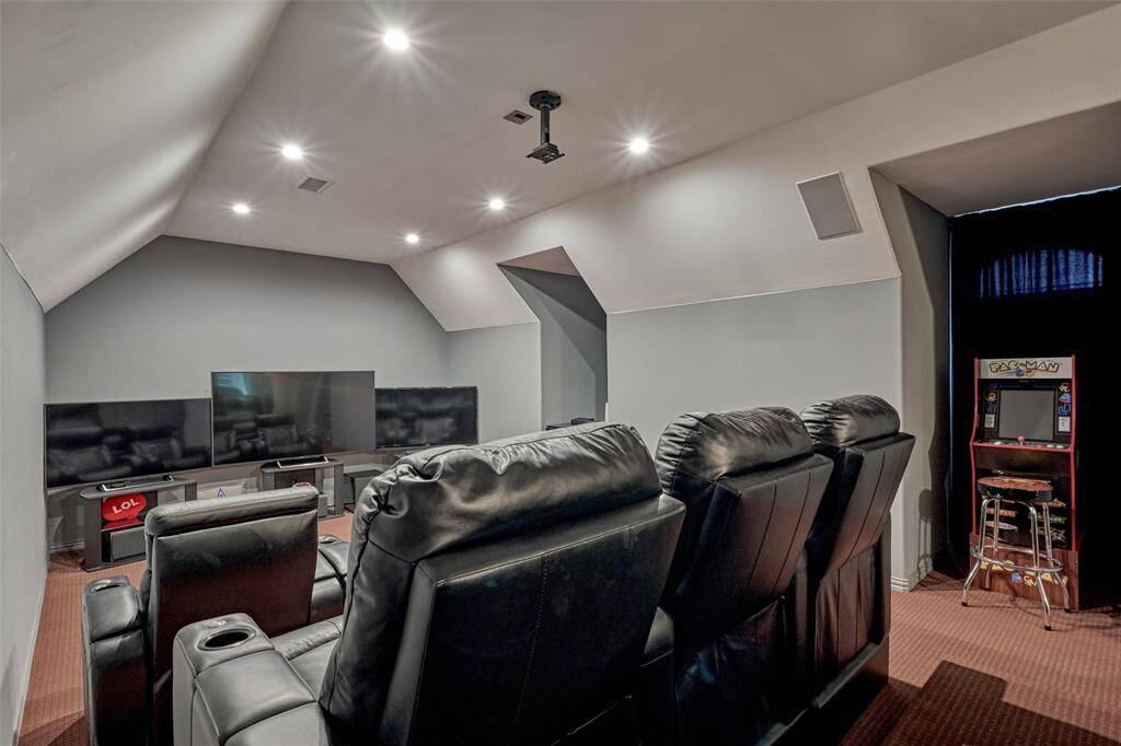Tiered flooring accommodates multiple rows of theater-style seating, ideal for everyone to enjoy multiple TVs or a projector and screen setup.