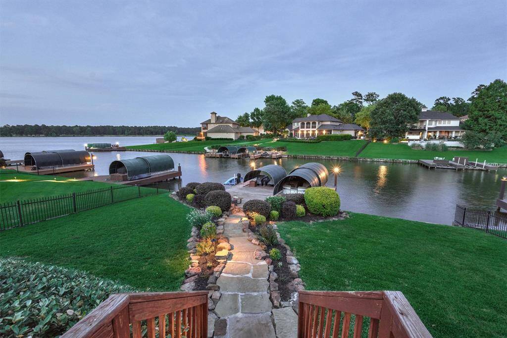 Landscape lighting and a flagstone path leads to the boat slip and dock.