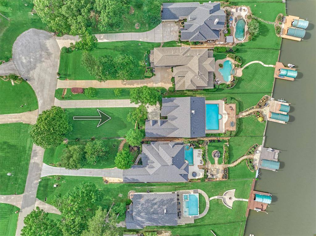 An aerial view highlights the lot footprint, extended driveway, and generous yard space, offering a clear picture of the home's layout and outdoor space.