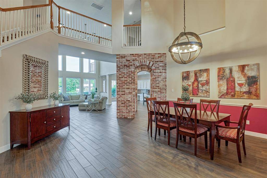 Step inside and you're greeted by charming brick accents and a stunning wall of windows that frame breathtaking views of the lake.