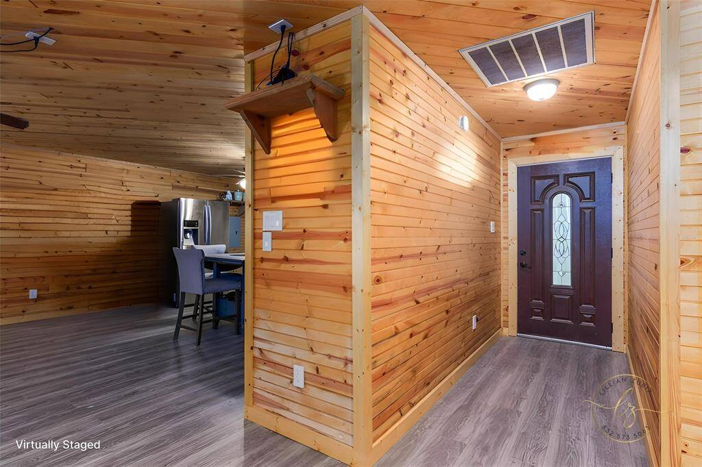 Enter into your lake house and embrace the log cabin feel of pine throughout