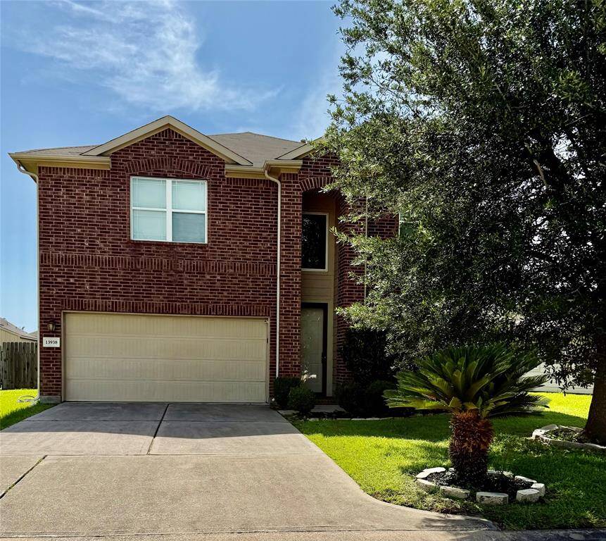 Charming two-story brick home with a double garage and well-maintained front yard. Features mature trees and a neat driveway. Perfect for families.