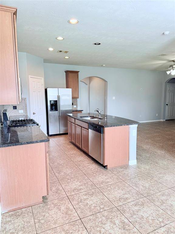 An open layout connects to living room area, offering ample natural light and a modern feel.
