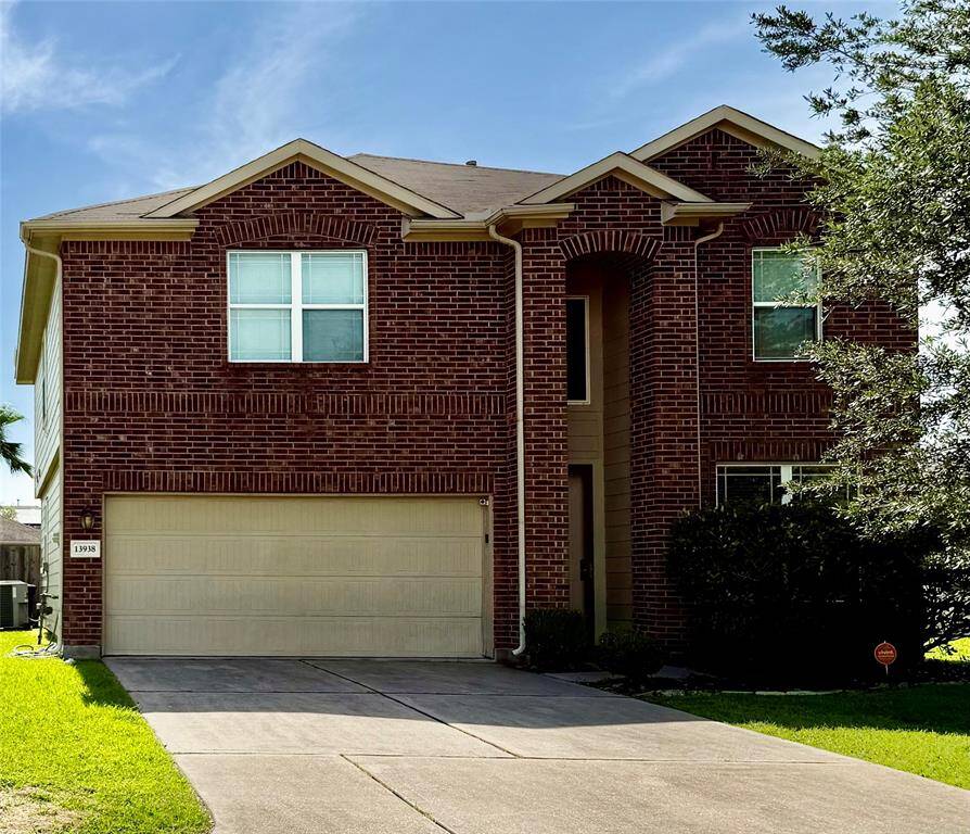 Charming two-story brick home with a double garage and well-maintained front yard. Features mature trees and a neat driveway. Perfect for families.