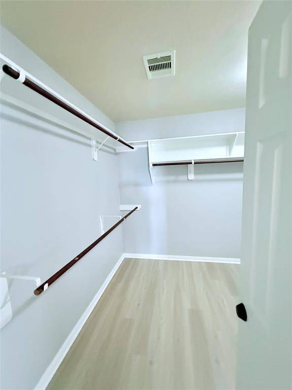 Expansive walk-in closet with ample shelving and hanging space, perfect for organizing your wardrobe.