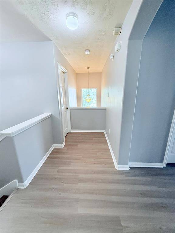 Bright and inviting second-floor view to the entryway downstairs.