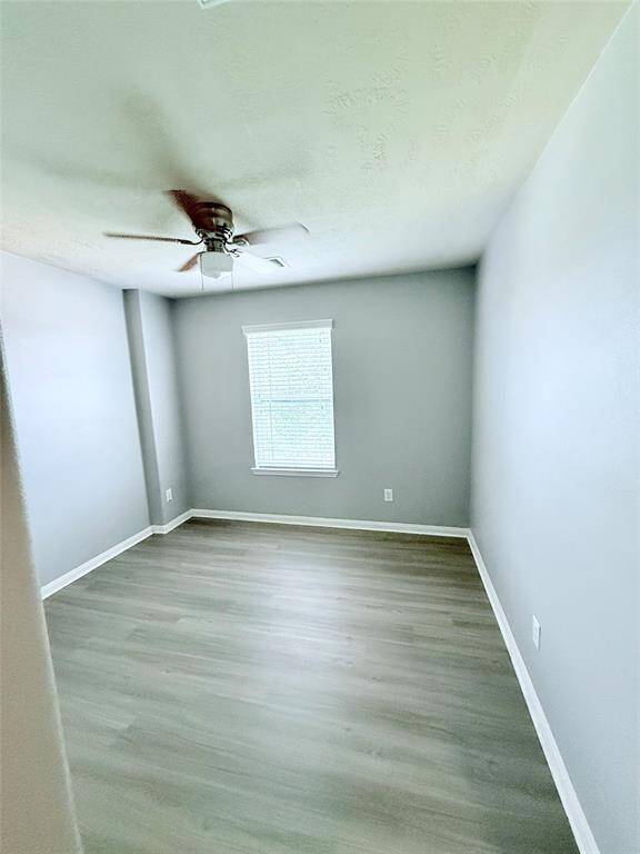 Cozy third bedroom featuring natural light and modern flooring, perfect for guests or a home office.