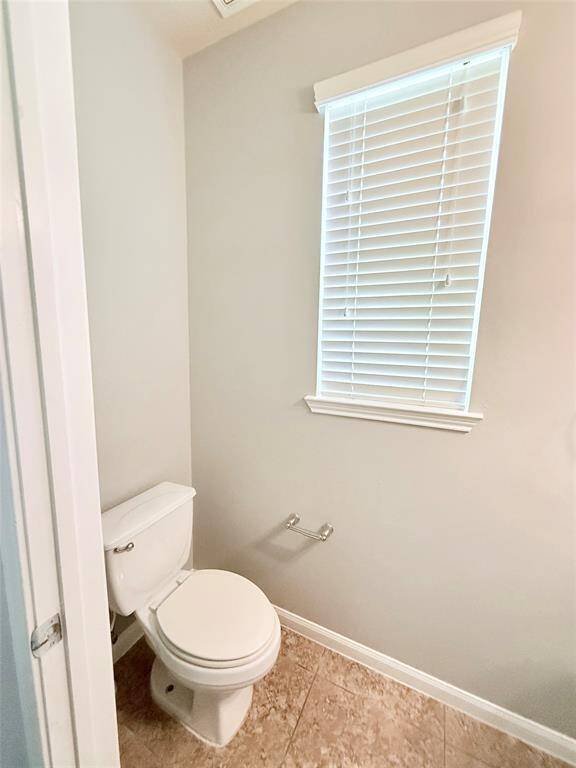Convenient half bath with natural light.