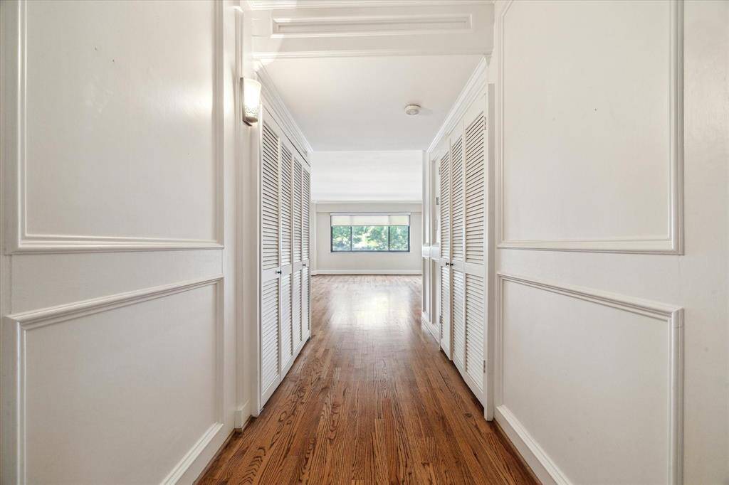 Paneled hallway going from entry to the living room.