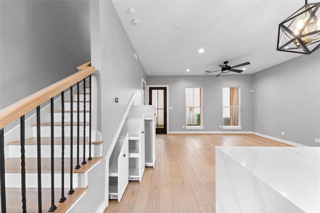 Innovative pull out storage drawers make use of the space under the stairs.