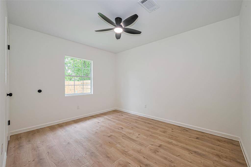 12x10 Secondary room with new floor, paint and remote controlled fan