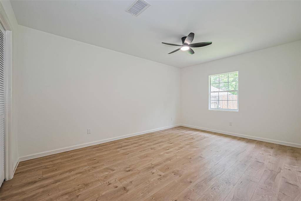Primary room with with new floor, paint and remote controlled fan