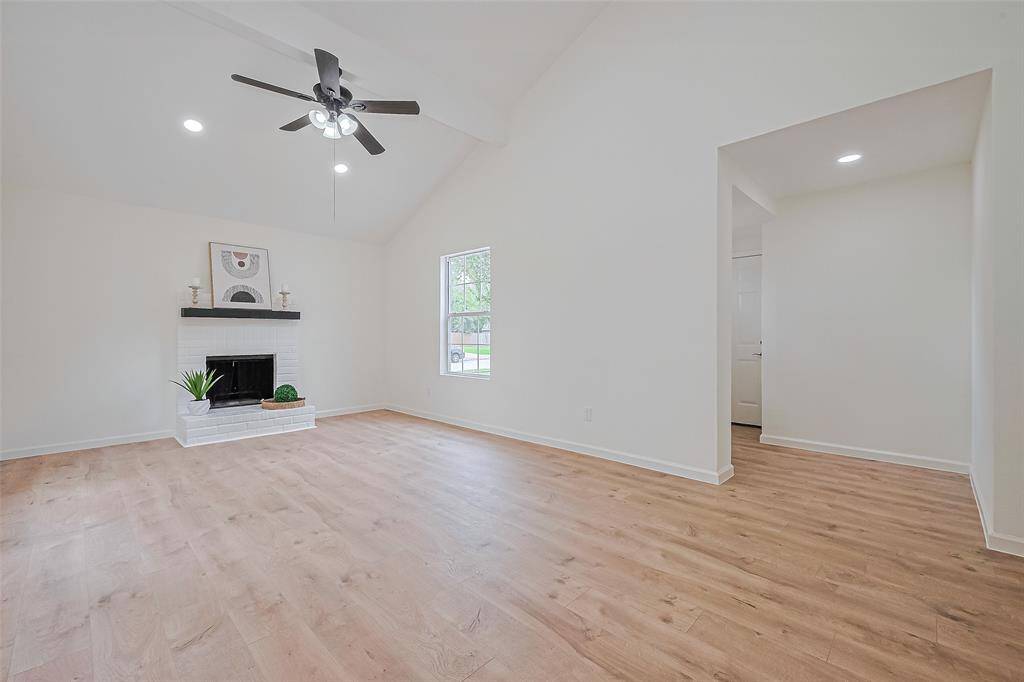 Open living area with high ceilings, recessed lighting