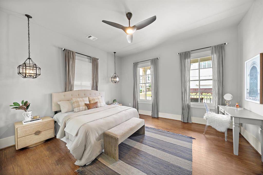 Get ready every morning at this custom built vanity table. Or use that space as a seating area in room! This primary bedroom has 5 windows - so much natural light. The rear windows look into the big backyard!