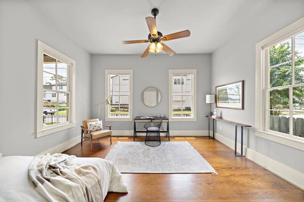 Spacious guest bedroom with 4 windows - so much natural light!! Custom built Murphy queen-sized bed tucked into a corner of the room - such a smart use of space! Currently also set up with a desk area - who wouldn't want to work from home in here?