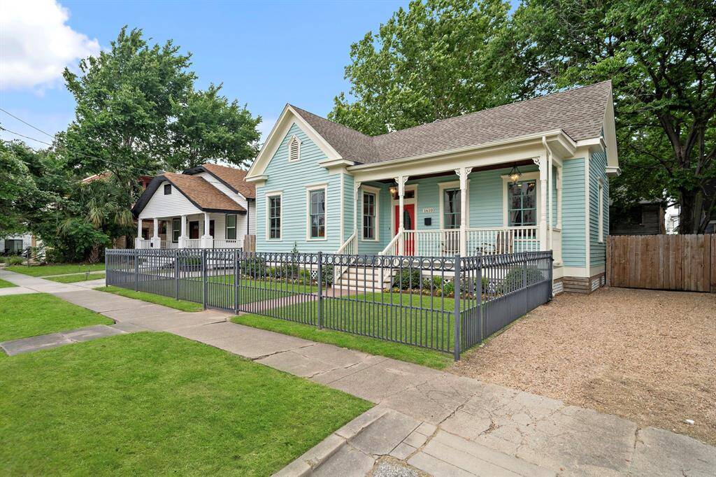 The entire EXTERIOR of the home is newly repainted (2025). Wrought iron fence with good sized front garden. GUTTER above the front porch. Paver walkway leading up to the welcoming front porch!