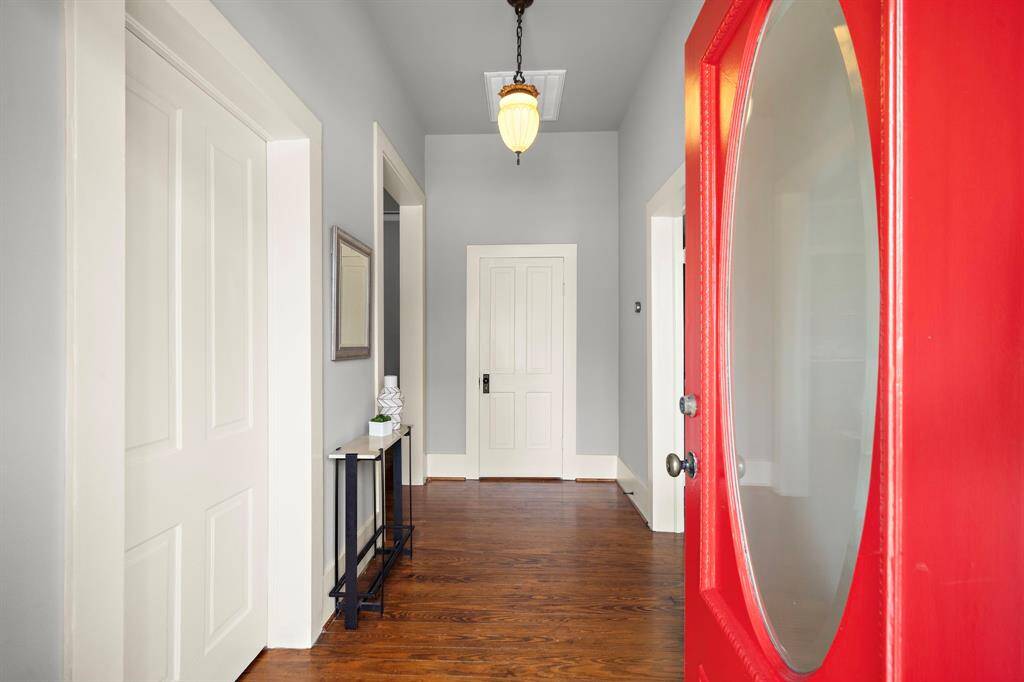 Come through the AMAZING solid wood front door (with transom window / not pictured) into a welcoming front foyer. Note the antique light fixture, 12' ceilings and solid wood floors!