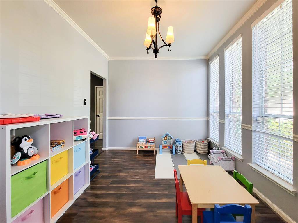 Formal Dining. Currently being used as Play-room for kids. Note the crown & chair molding. Recent paint.