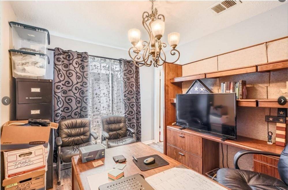 This photo showcases a cozy home office with ample natural light.