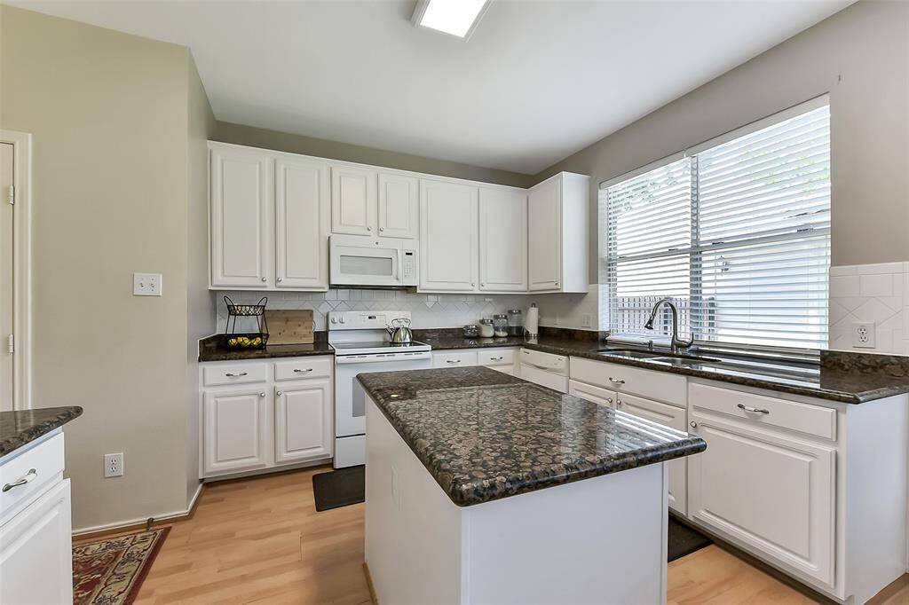Kitchen has great counterspace and cabinets have been newly painted.