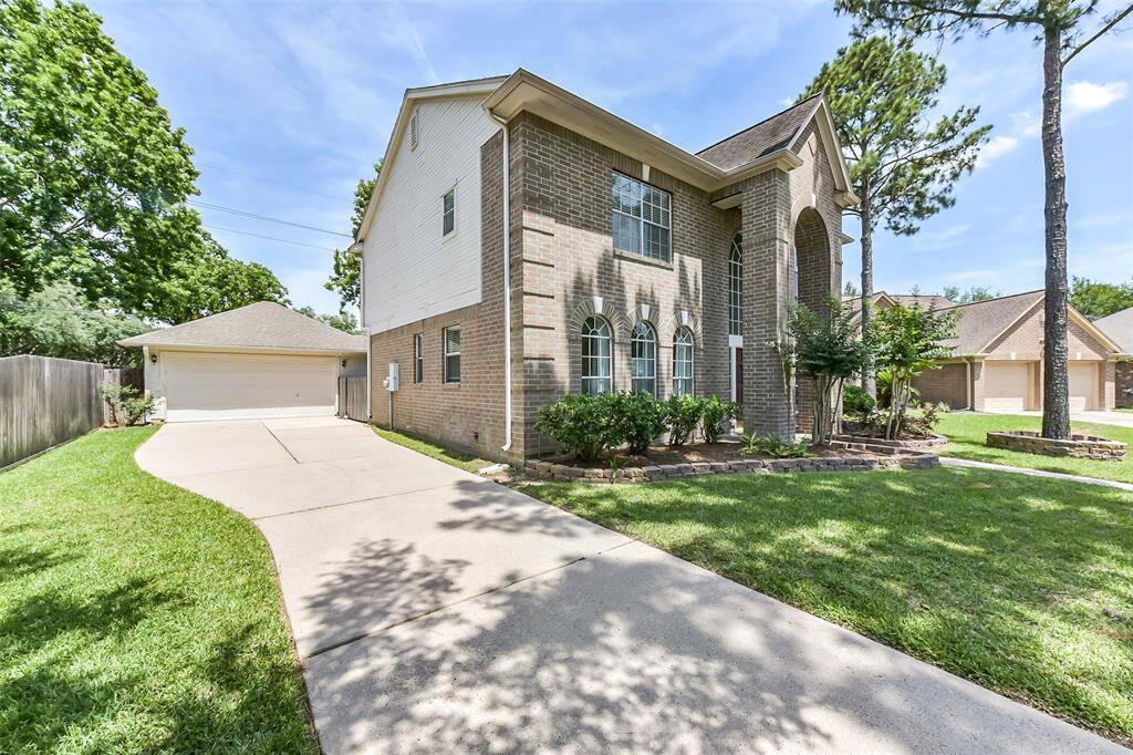 Large driveway with detached garage.