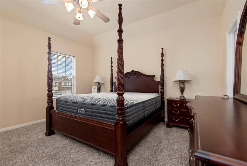 Spacious primary bedroom fits all of this furniture!
