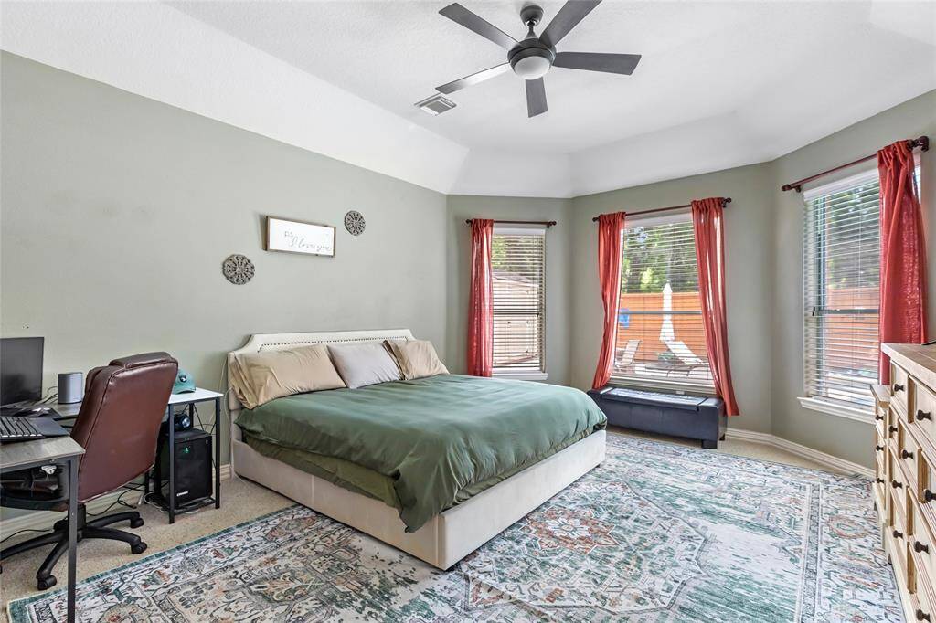 Primary bedroom overlooks the backyard.