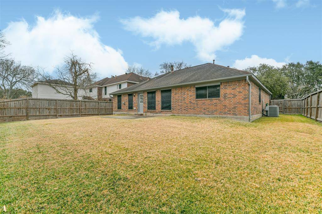 Spacious back yard. Great size for your doggies and plenty of room to enlarge your backyard experience. Solar Screens keeps the heat out.