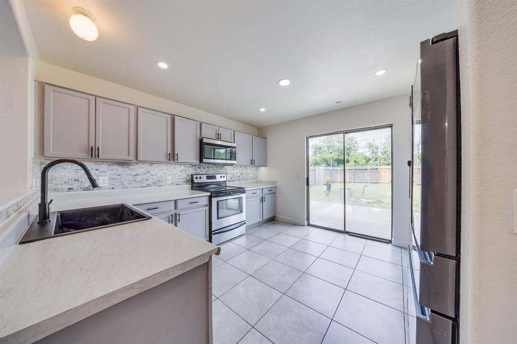 Kitchen with convenient access to the backyard, perfect for indoor-outdoor living and easy entertaining.