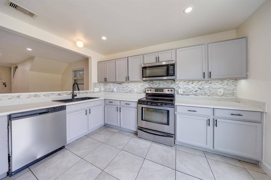 Kitchen offers ample cabinetry, providing plenty of storage space for all your cooking essentials.
