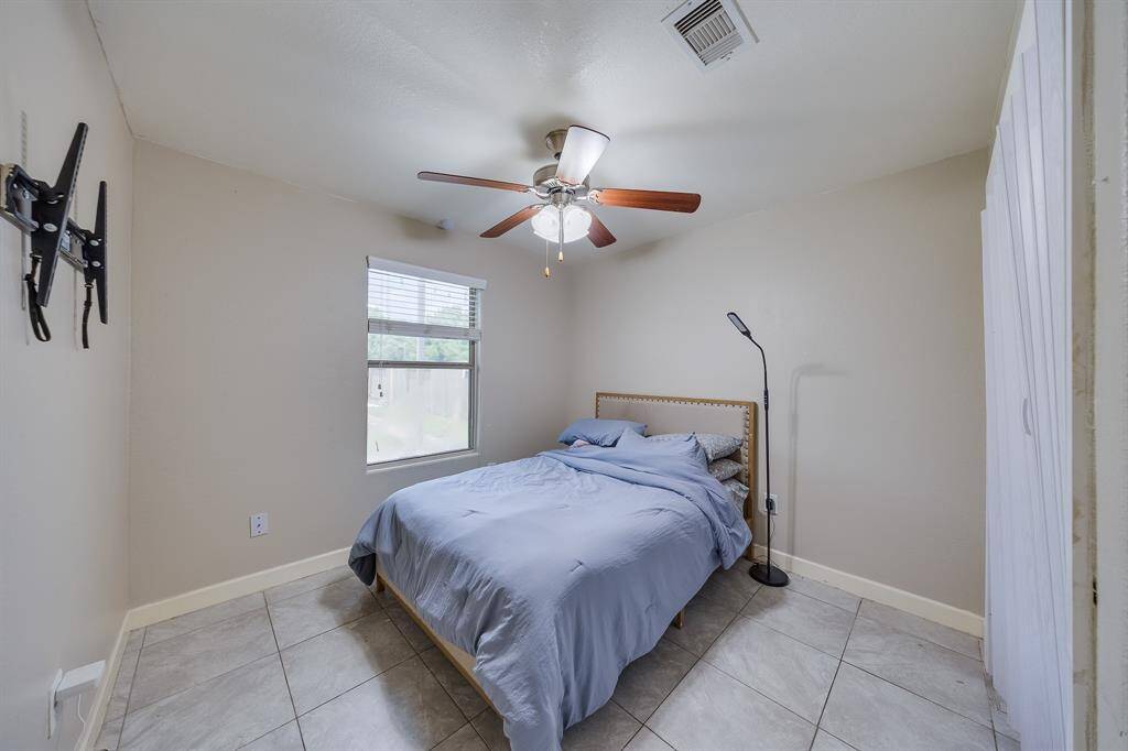 Warm light streams through the window into the bedroom located on the 1st floor, creating a cozy atmosphere.