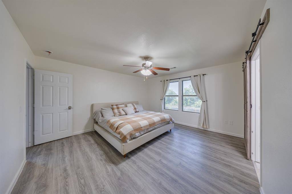 Spacious primary bedroom offers comfort and relaxation with ample natural light and room for a cozy sitting area.